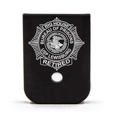 Bureau of Prisons badge design engraved on a magazine base plate
